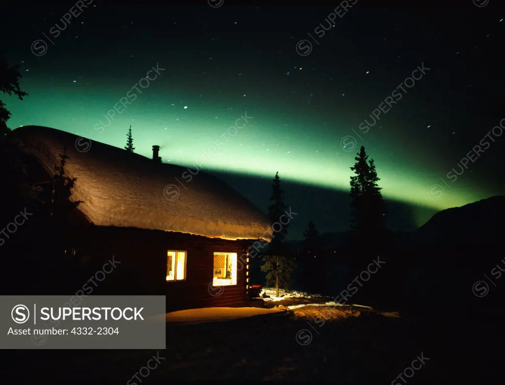 Green aurora arcing above cabin on Colorado Lake, Broad Pass, night of March 23-24, 2001, Alaska.