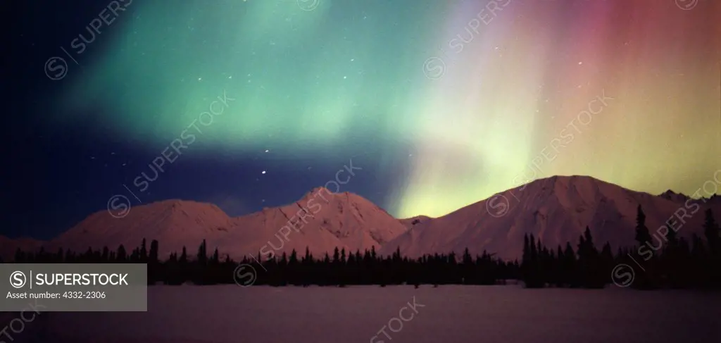 Beautiful green, red and purple aurora above the Talkeetna Mountains and Colorado Lake, geomagnetic storm during the early morning hours of March 31, 2001, Broad Pass, Alaska.