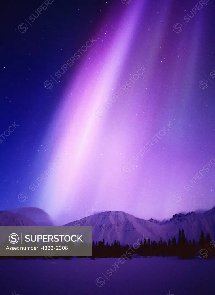 Purple and blue aurora above the Talkeetna Mountains and Coolorado Lake with subtle blue light of the approaching dawn, geomagnetic storm on March 31, 2001, Broad Pass, Alaska.