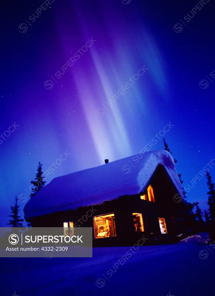 Auroral rays at dawn over cabin on the shore of Colorado Lake, geomagnetic storm on March 31, 2001, Broad Pass, Alaska.