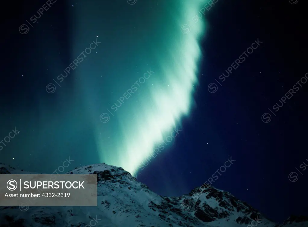 Brilliant green active aurora over the Talkeetna Mountains near Hatcher Pass with light of the approaching dawn, geomagnetic storm on morning of November 6, 2001, Alaska.