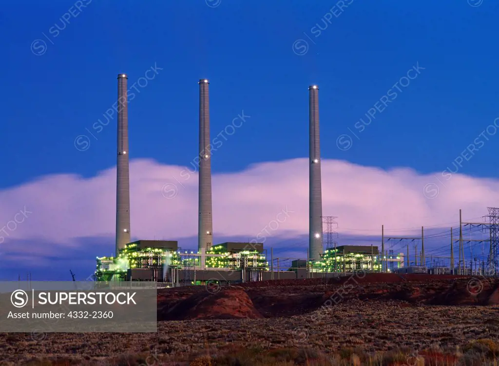 Dusk descending over the Navajo Generating Station, a coal-fired powerplant with the capacity of 2,280 megawatts located on the Navajo Reservation near Page, Arizona.  Plant burns coal from the Peabody Western Coal Company;s Kayenta Mine at releases an estimated 19.9 million tons of Carbon Dioxide annually.