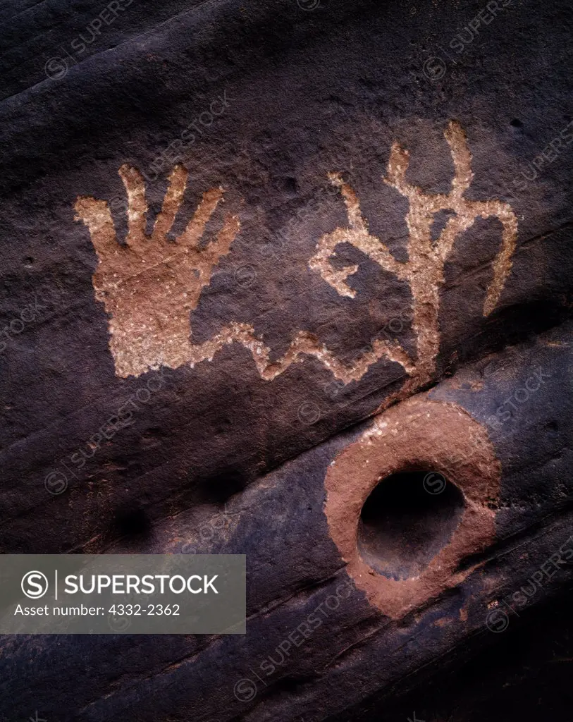 Ancestral Pueblo petroglyph of a hand connected to a plant emerging from a natural hole in a sandstone wall, tributary to the Little Colorado River drainage, Arizona.  SC