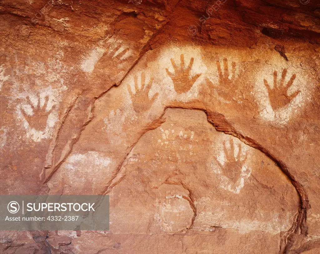Ancestral Pueblo pictographs of negative hand prints made with sprayed white pigment, Cave in Canyon de Chelly, Canyon de Chelly National Monument, Arizona.