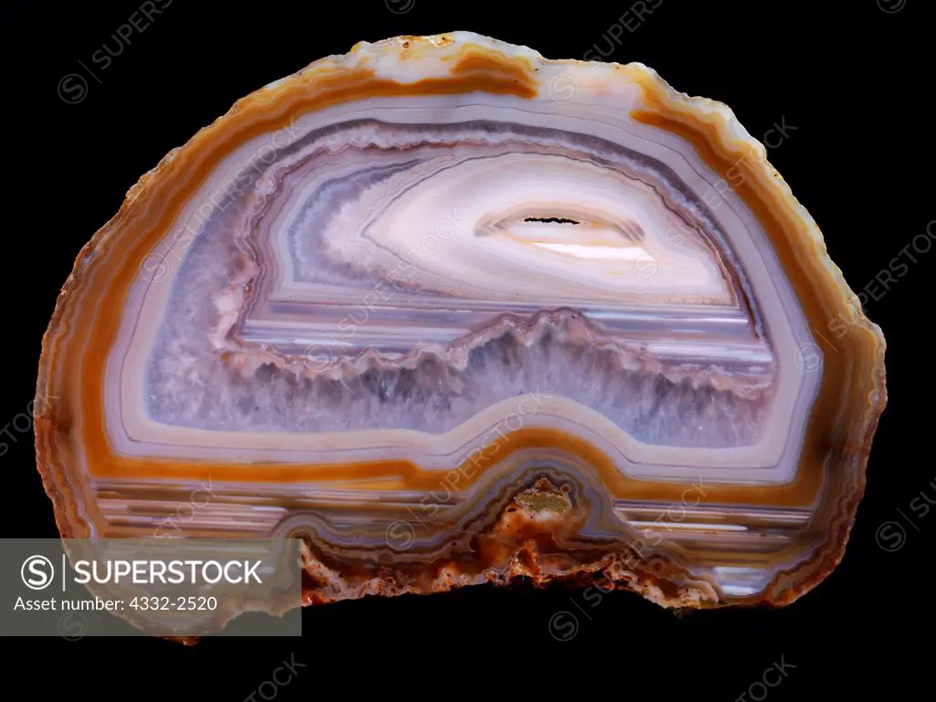 Beautiful slab of Piranha Agate from Brazil showing multiple periods of waterline deposition, quartz crystal growth and fortification agate banding.