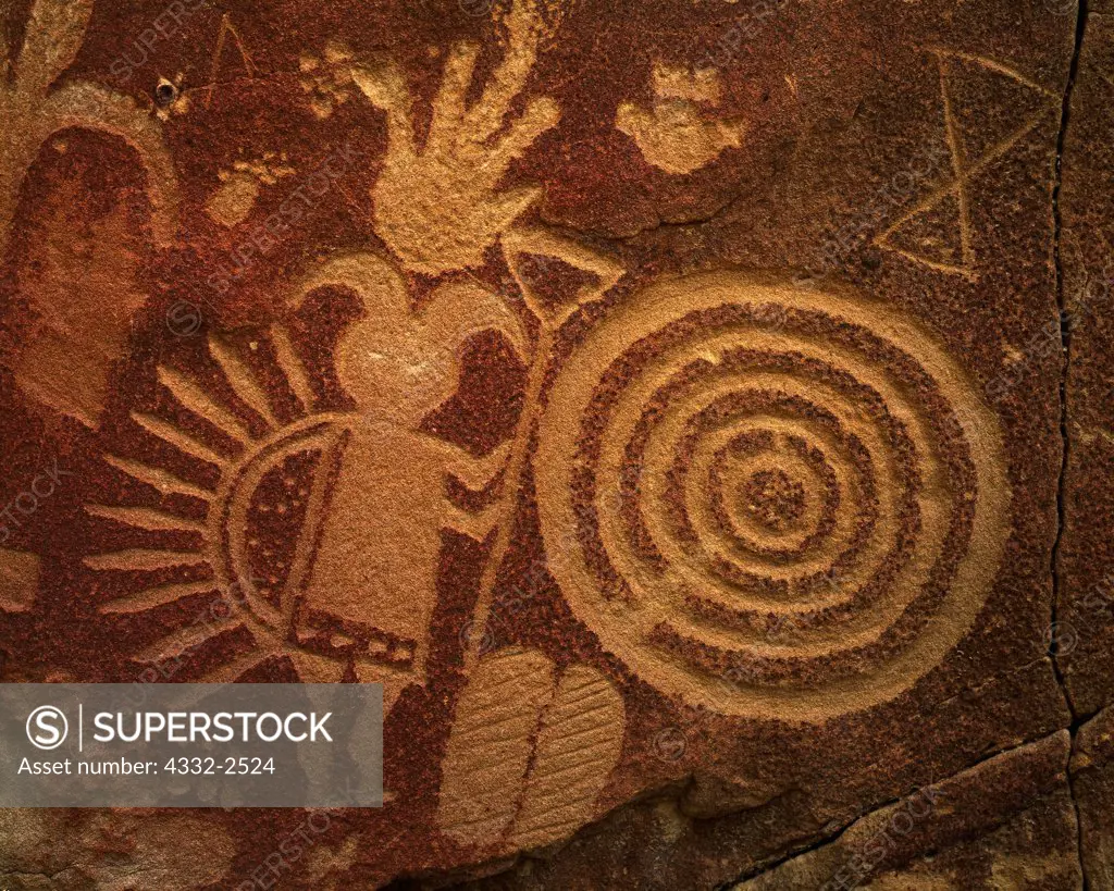 Petroglyphs of Ghaan'ask'idii, Humpbacked God, concentric circles and the hourglass symbol of Born-for-Water, Gobernador Representational Style, Largo Canyon tributary, Dinetah, New Mexico.