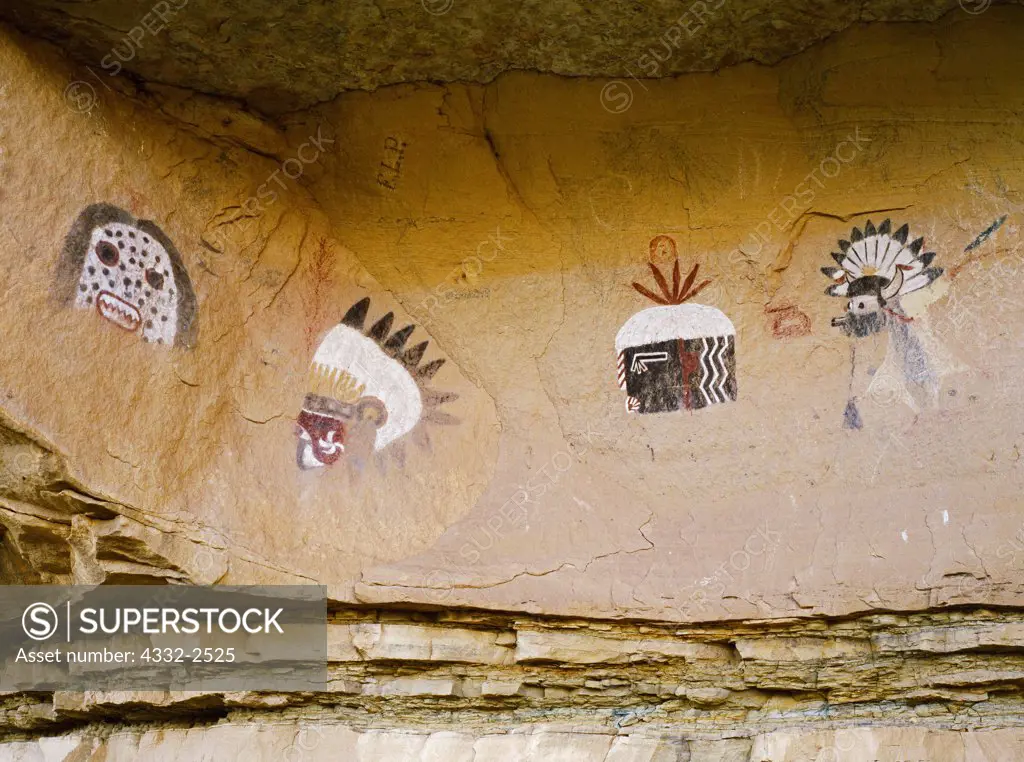 Historic Zuni pictographs of 'Atoshle', a male scare kachina, 'Kumance', a Comanche, 'Hehe'a', the Blunderer kachina, and 'Shalako', a messenger from the rain gods, Village of the Great Kivas, Zuni Reservation, New Mexico.