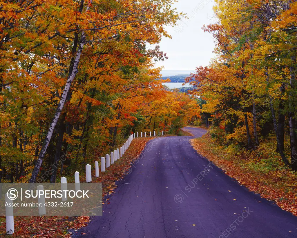 Brockway Mountain Drive winding through beautiful autumn foliage as the road descends to Copper Harbor, Keweenaw Peninsula, Upper Peninsula of Michigan.