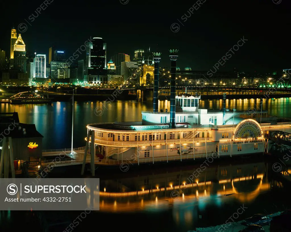 Night view of the Cincinnati, Ohio across the Ohio River with the riverboat 'Cincinnati & New Orleans Spirit of America in the foreground, Covington, Kentucky.