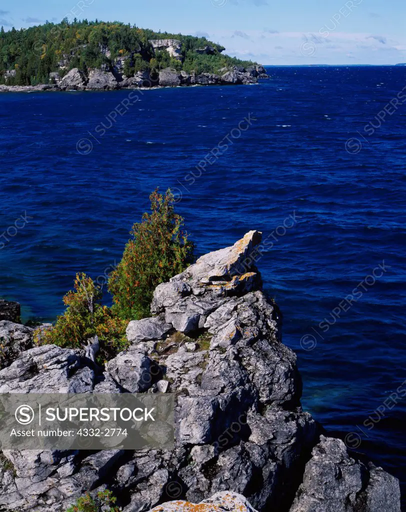 Azure waters of Geogian Bay, Lake Huron.  View west toward Overhanging Point from Halfway Rock Point, Bruce Trail, Bruce Peninsula National Park, Ontario, Canada.