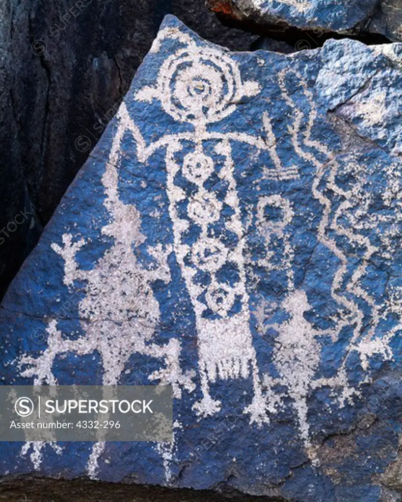 Coso Range petroglyph panel featuring a decorated anthropomorphic figure with a lizard dangling from its right arm, Department of Defense Lands, Naval Weapons Station, China Lake, California.