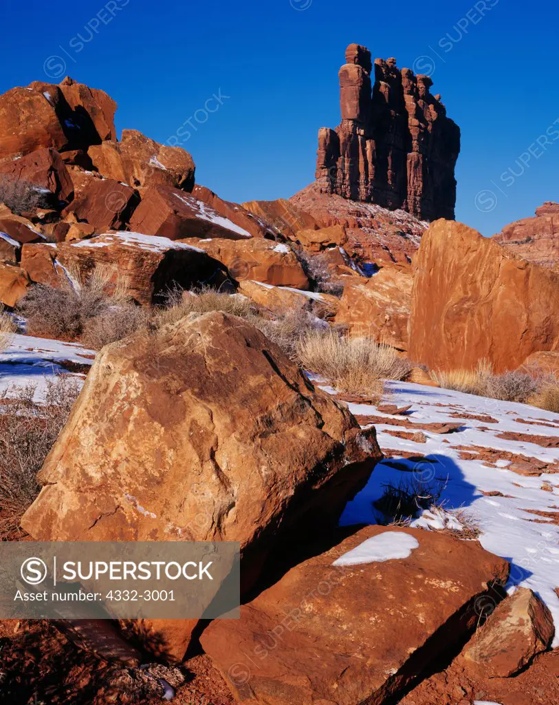 Cedar Mesa Sandstone monolith on sloping brick red Hilgaito Shale, Valley of the Gods, Utah.