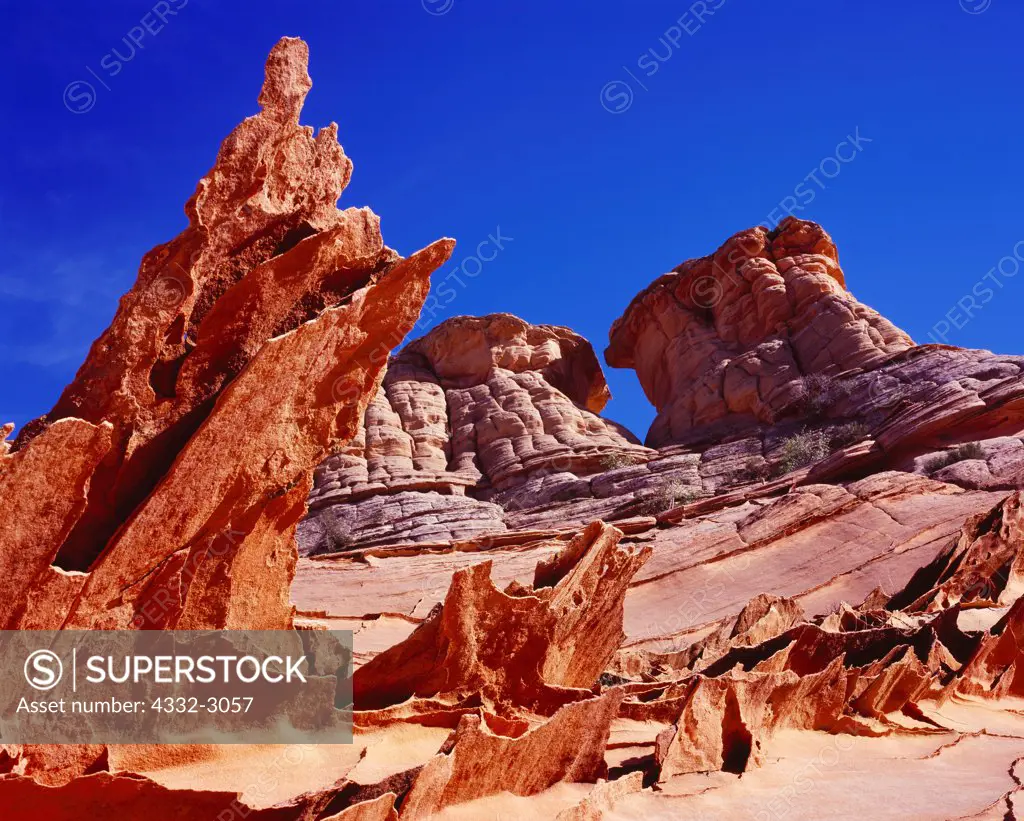 Paper-thin fins of wind-eroded Navajo Sandstone with Navajo Sandstone knolls beyond, Paria Canyon-Vermilion Cliffs Wilderness, Utah.   CB