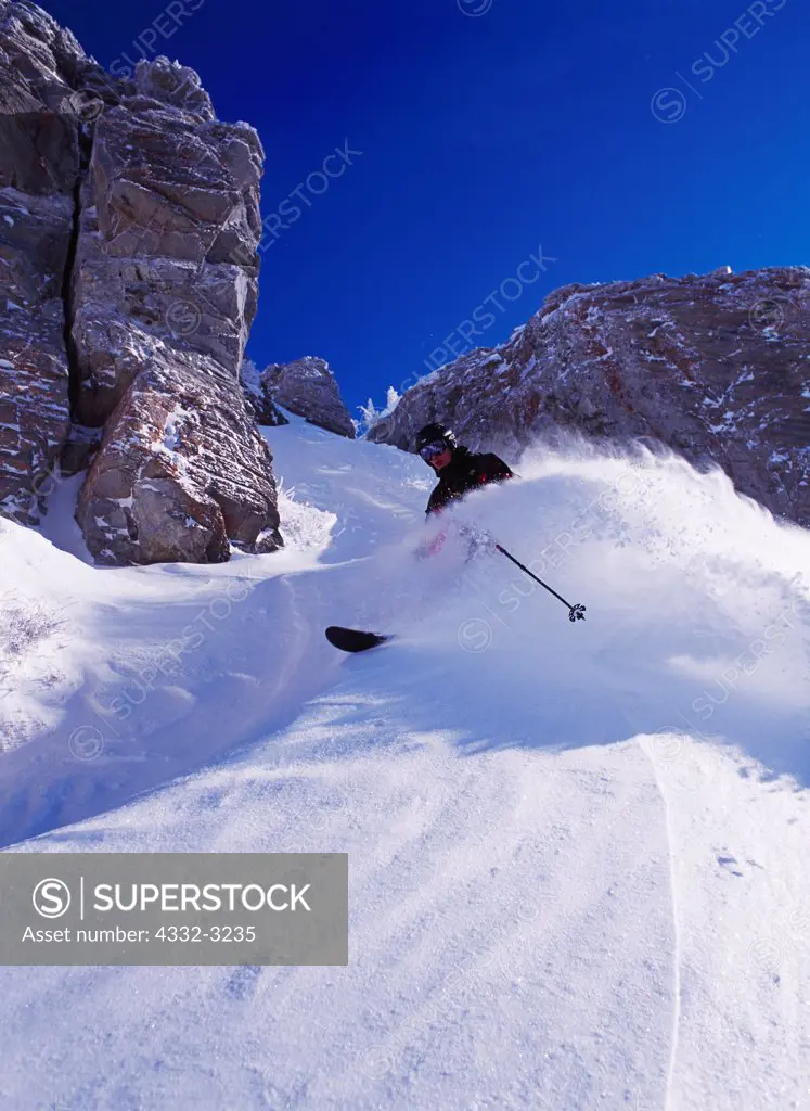 Alpine skier Dylan Crossman enjoying deep powder at Alta, Little Cottonwood Canyon, Wasatch Range, Utah.