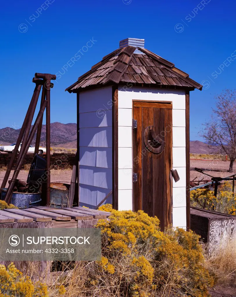 USA, Utah, Modena, Sparkling white outhouse with cedar shake roof and cedar door