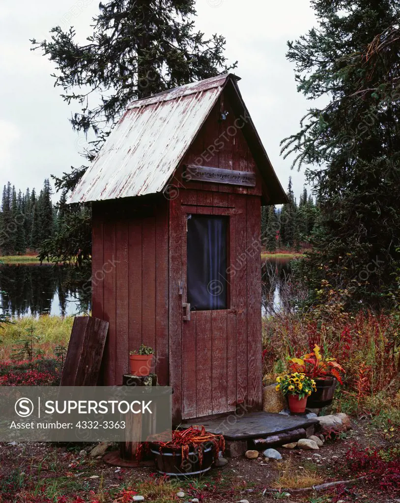 USA, Alaska, Broad Pass, Outhouse with Colorado Lake in background