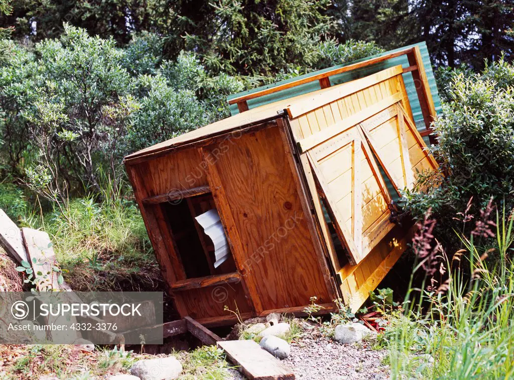 USA, Alaska, Lake Clark National Park, Twin Lakes, Gary Titus's Windsong Lodge, Outhouse knocked over by black bear looking for goodies to eat