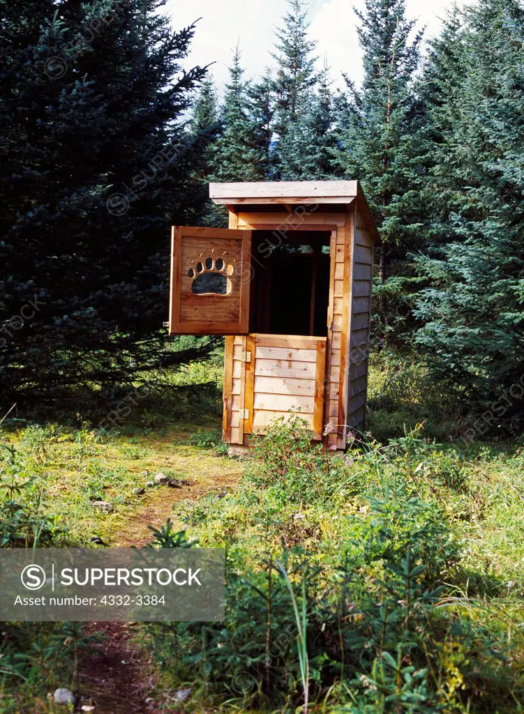 USA, Alaska, Lake Clark National Park, Silver Salmon Creek, National Park Service Ranger Cabin, Brown Bear Paw carved window in outhouse