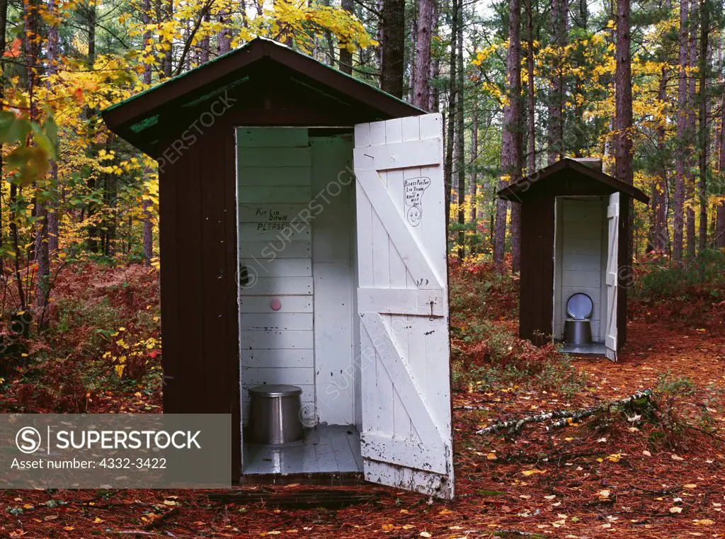USA, Michigan, Upper Peninsula of Michigan, Culhane Lake State Forest Campground, Pair of outhouses in north woods