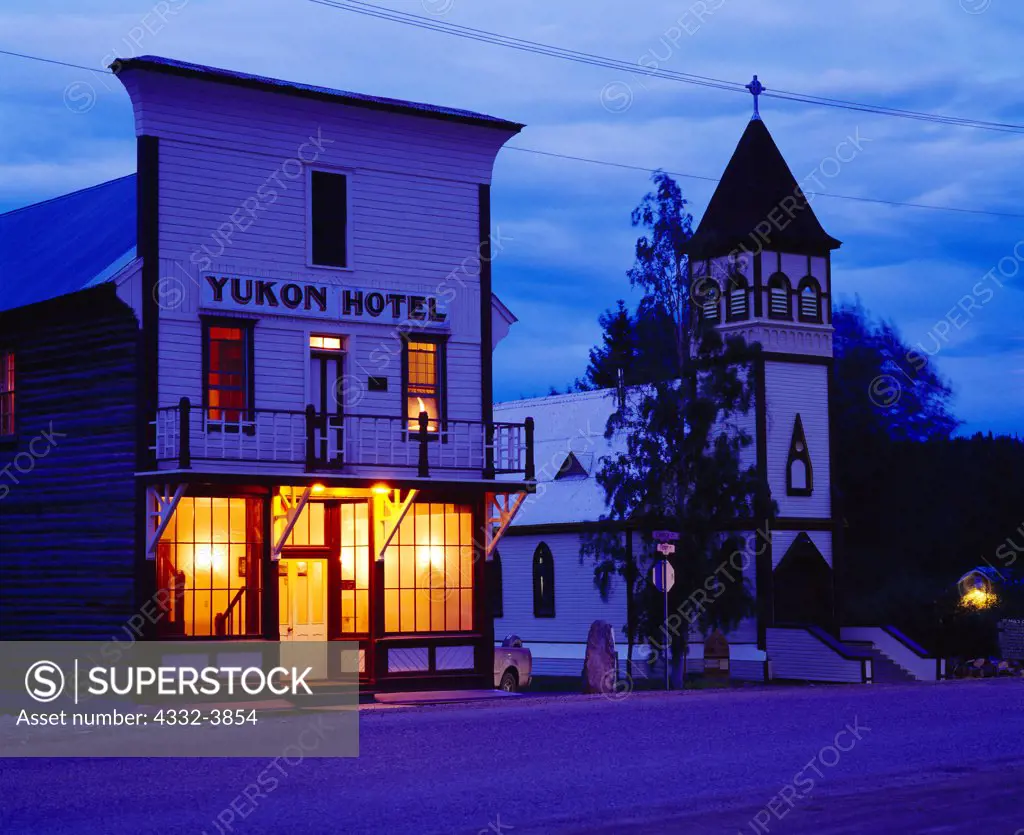 Canada, Yukon Territory, Dawson City, Yukon Hotel, two story log building with facade of milled lumber built in 1898, and Saint Paul's Anglican-Episcopalian Church built in 1902, Klondike Gold Rush