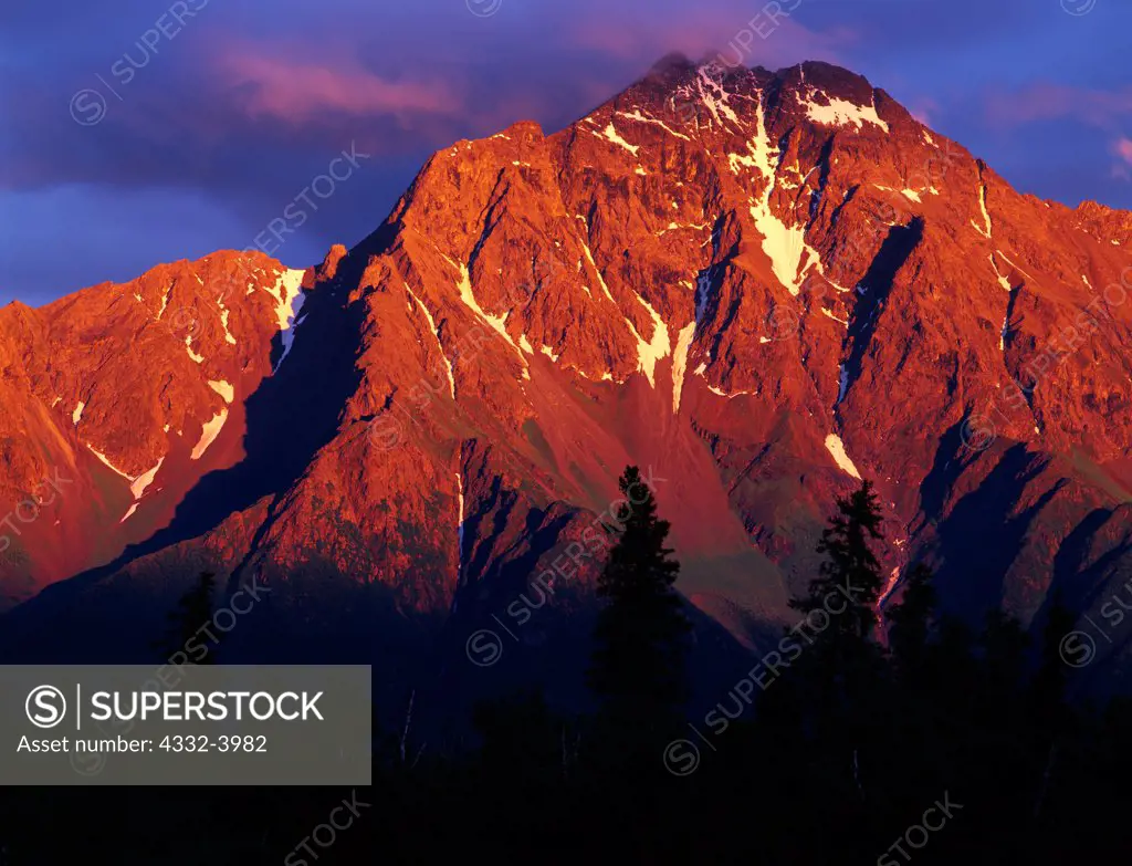 Pioneer Peak illuminated by warm light of sunset, Bodenburg Butte area, Matanuska Valley, Alaska.