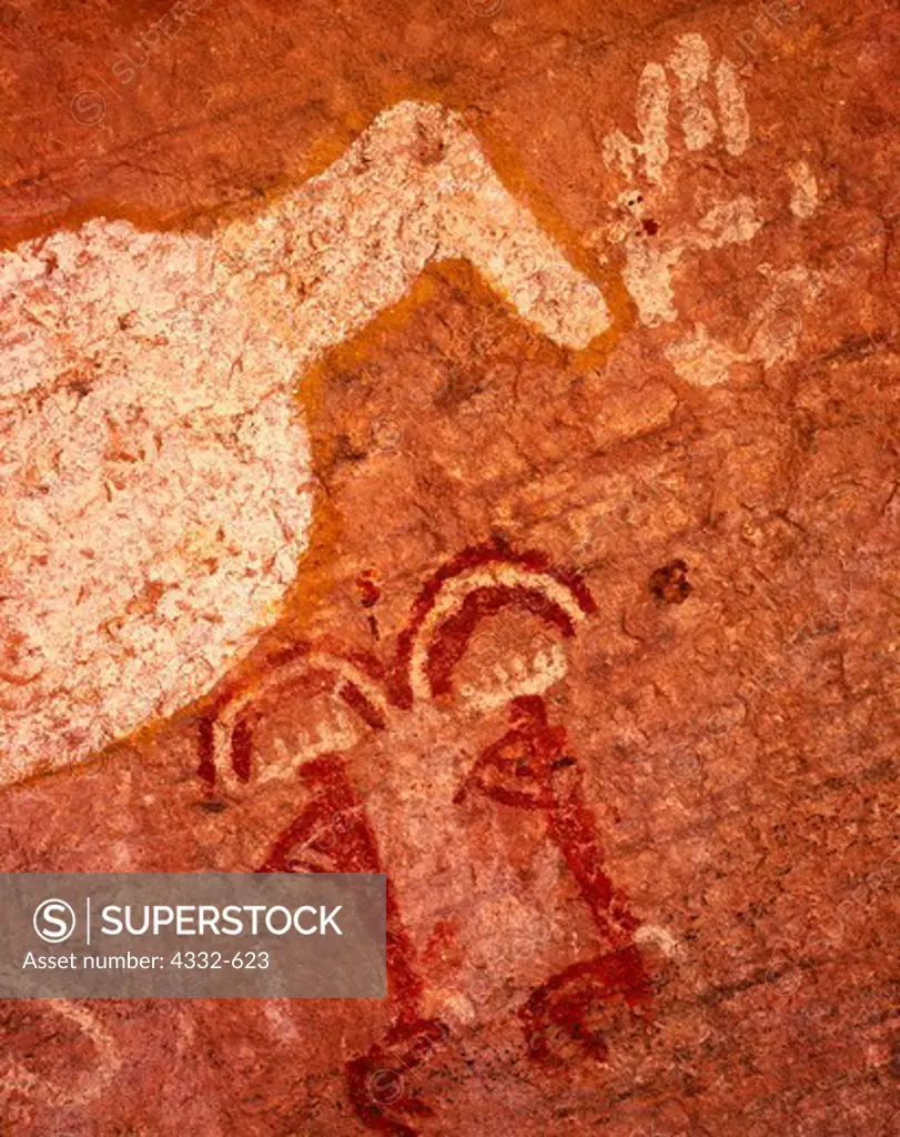 Pictographs of large white bird, perhaps a duck over twin flute players with rainbows above their heads, cave in Canyon de Chelly National Monument, Arizona (CDC-78)
