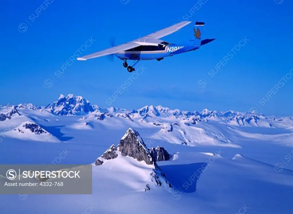 Wings of Alaska Cessna 207 on wheels flying over the Juneau Icefield, Alaska.