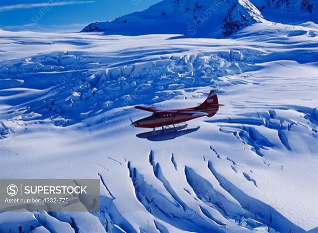 Rust's Flying Service turboprop de Havilland Otter on floats flying above the highly crevassed Harriman Glacier, Chugach National Forest, Alaska.