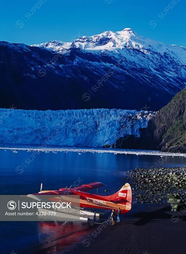 Rust's Flying Service turboprop de Havilland Otter on floats along the shore of Barry Arm of Port Wells with the Barry Glacier beyond, Chugach Mountains, Chugach National Forest, Alaska.