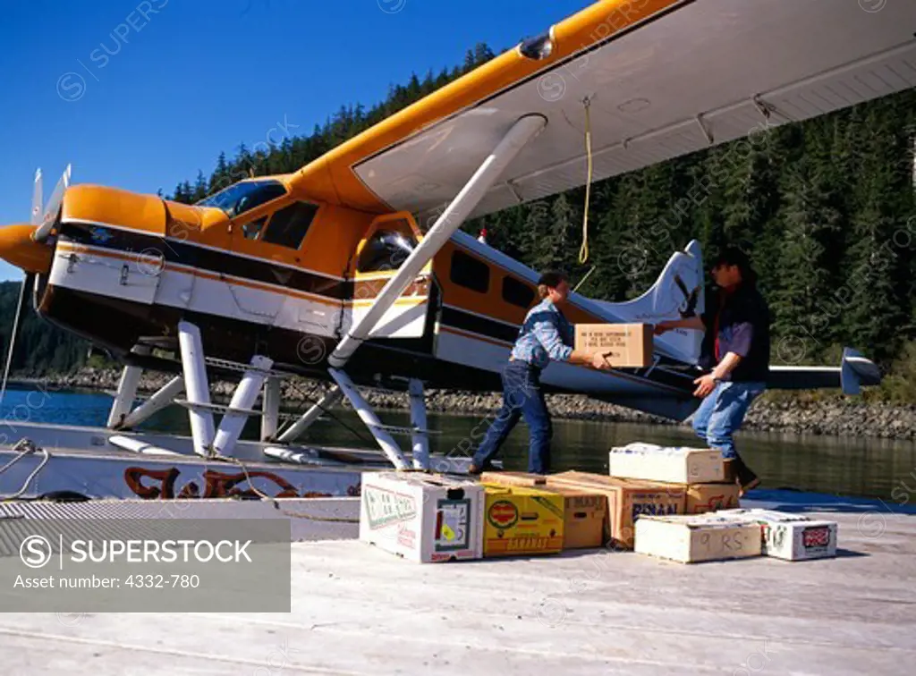 Groceries being off-loaded from Wings of Alaska de Havilland Beaver onto dock at Elfin Cove, Chichagof Island, Southeast Alaska.