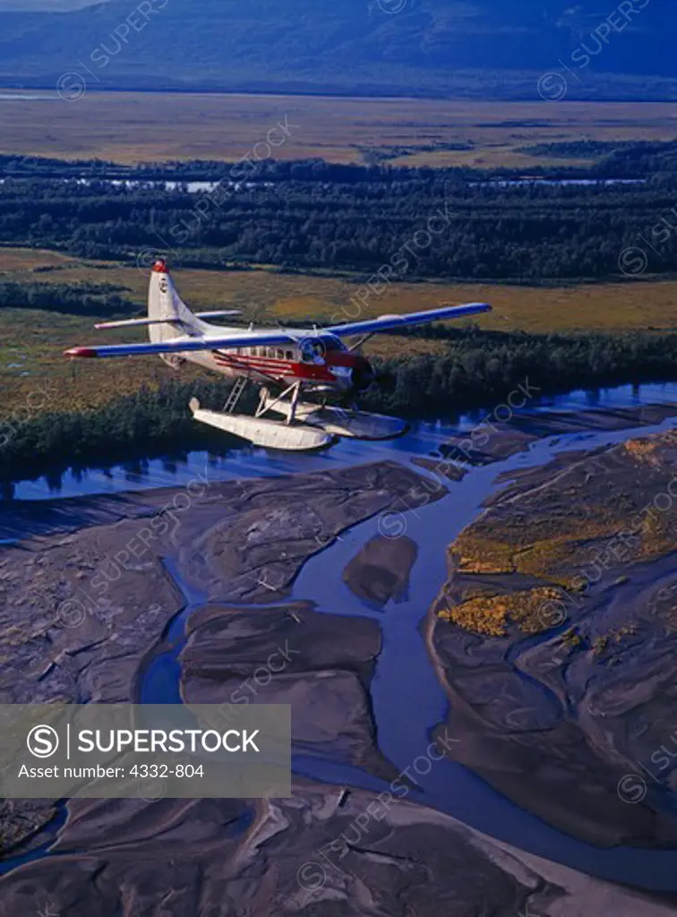 Bush Pilots Air Service de Havilland DHC3 Otter flying over braided channel of the Susitna River near Cook Inlet, Alaska.