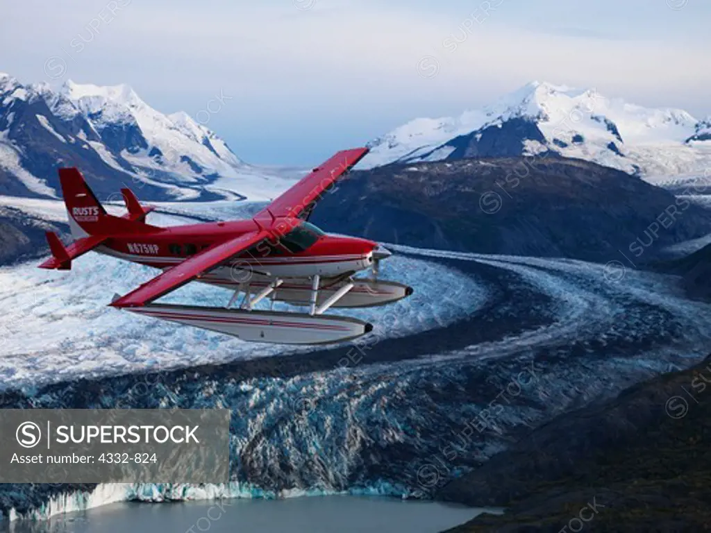 Rust's Flying Service Cessna 208 Caravan on floats flying above Colony Glacier, Lake George, Alaska.