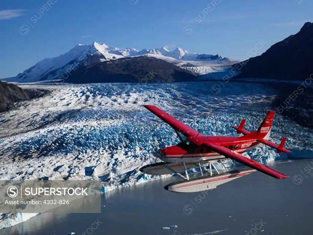 Rust's Flying Service Cessna 208 Caravan on floats flying above Colony Glacier, Lake George, Alaska.