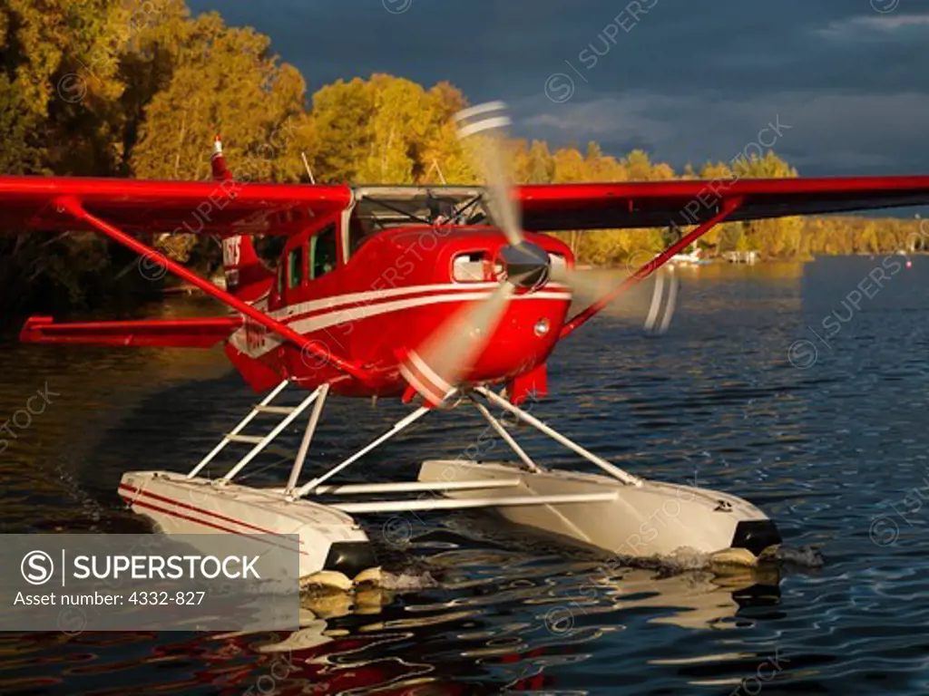Rust's Flying Service Cessna 206 on floats taxiing on Lake Lucille, Wasilla, Alaska.