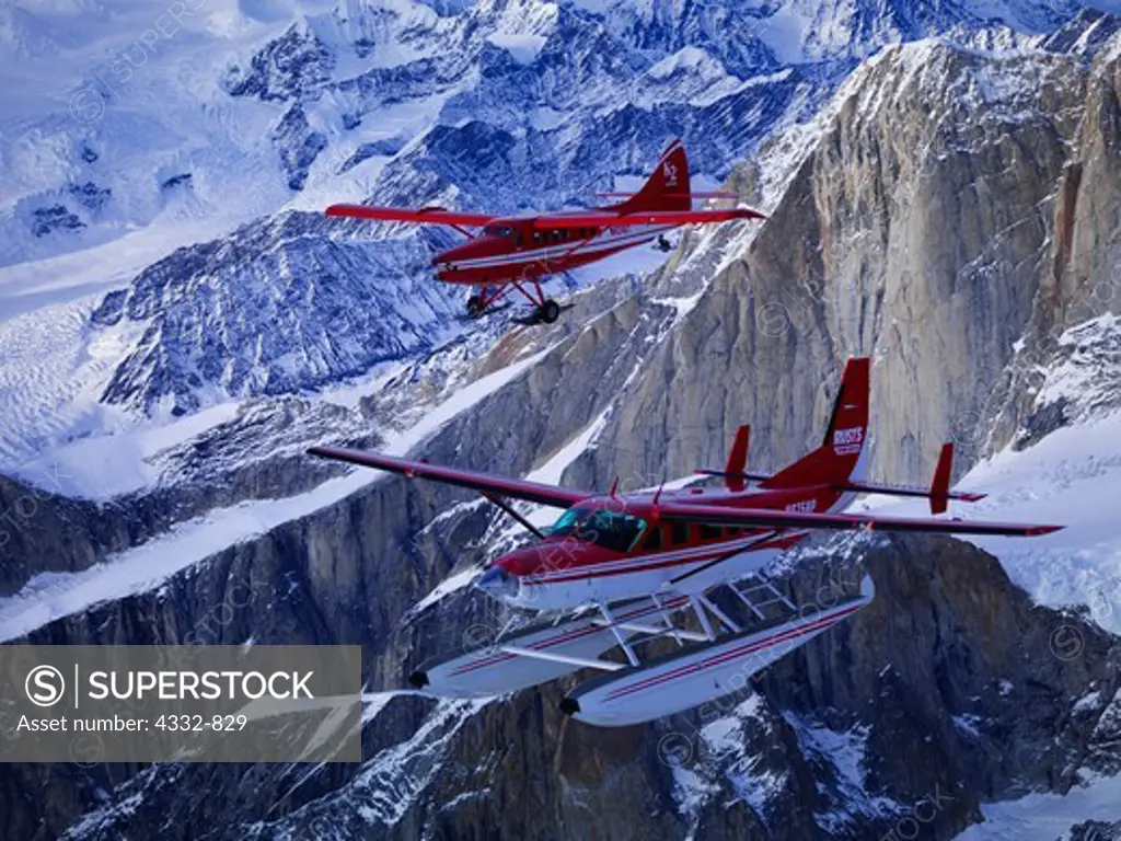 Rust's Flying Service Cessna Caravan on floats and K2 Aviation's Turbine Otter on wheel skis flying above The Mooses Tooth in Denali National Park, Alaska.