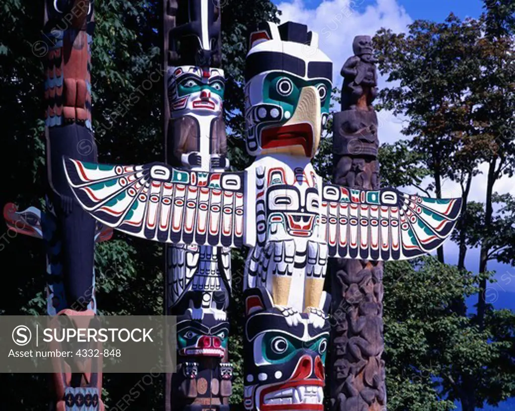 Pacific Northwest Coast totem poles including the Thunderbird House Post, a replica carved in 1987 by Tony Hunt of the house post created by Kwakwaka'wakw artist Charlie James in the early 1900s.  On display at Stanley Park, Vancouver, British Columbia, Canada.