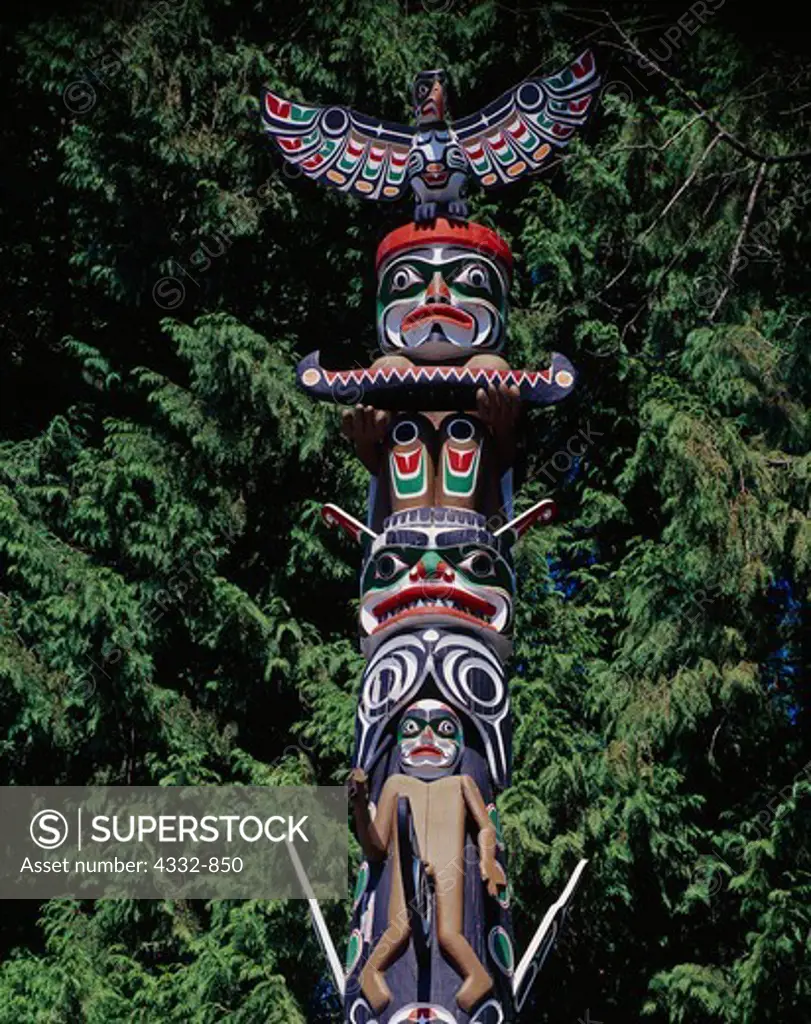 Legendary bird Quolus, Red Cedar-bark Man with Canoe, Double-headed serpent Sisiyutl and Siwidi figures on the Ga'akstalas Pole, carved by Wayne Alfred and Beau Dick in 1991 and based on a Kwakwaka'wakw design by Russell Smith.  Totem pole on display at Stanley Park, Vancouver, British Columbia, Canada.