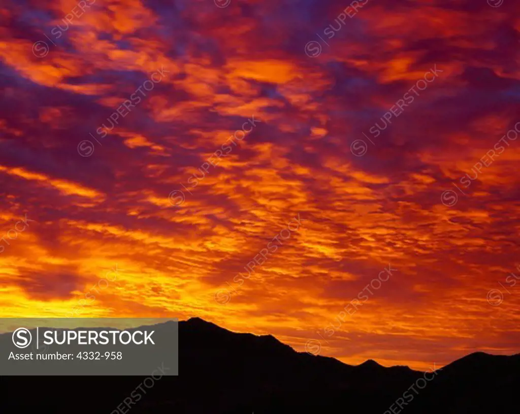 Fiery orange sunrise above Needle Peak, Butte Valley, Death Valley National Park, California.