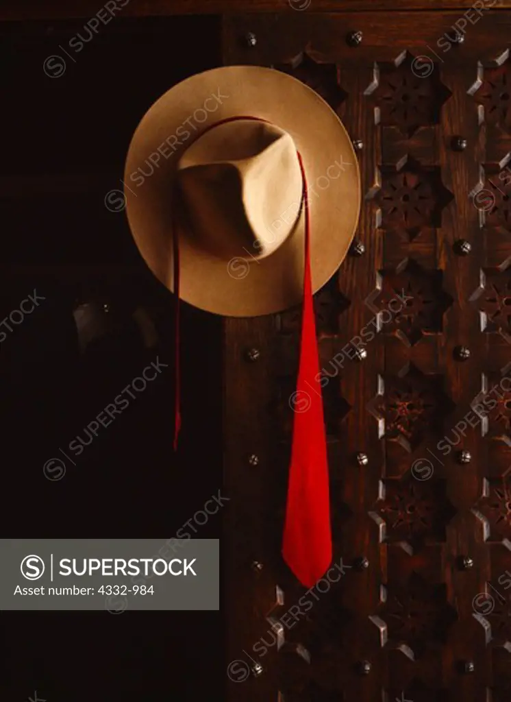Stetson and red necktie of Walter Scott's (Death Valley Scotty) hanging on wardrobe of white oak with leather panels, Scotty's Bedroom in Scotty's Castle, Death Valley Ranch, Death Valley National Park, California.