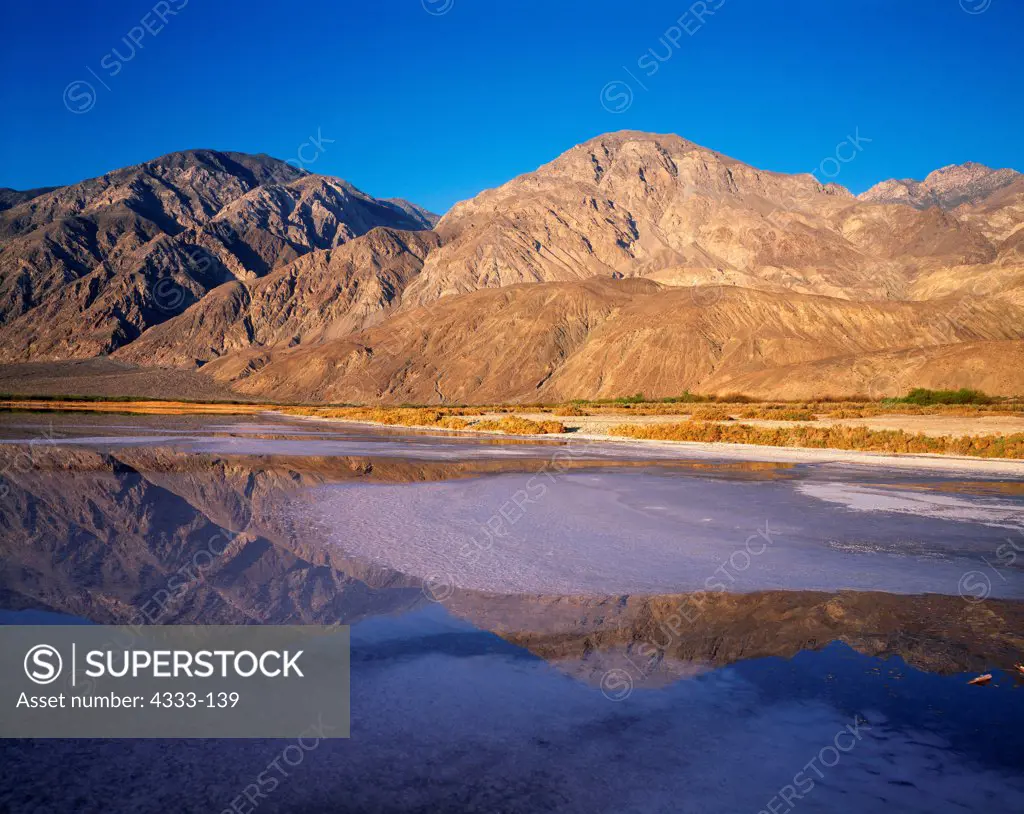 USA, California, Death Valley National Park, Saline Valley, inyo Mountains reflected in Salt Lake with salt pan advancing from shore