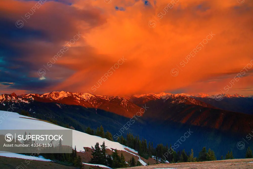 USA, Washington, Olympic National Park, Rain cloud over Olympic Mountains at sunset as seen from Hurricane Ridge