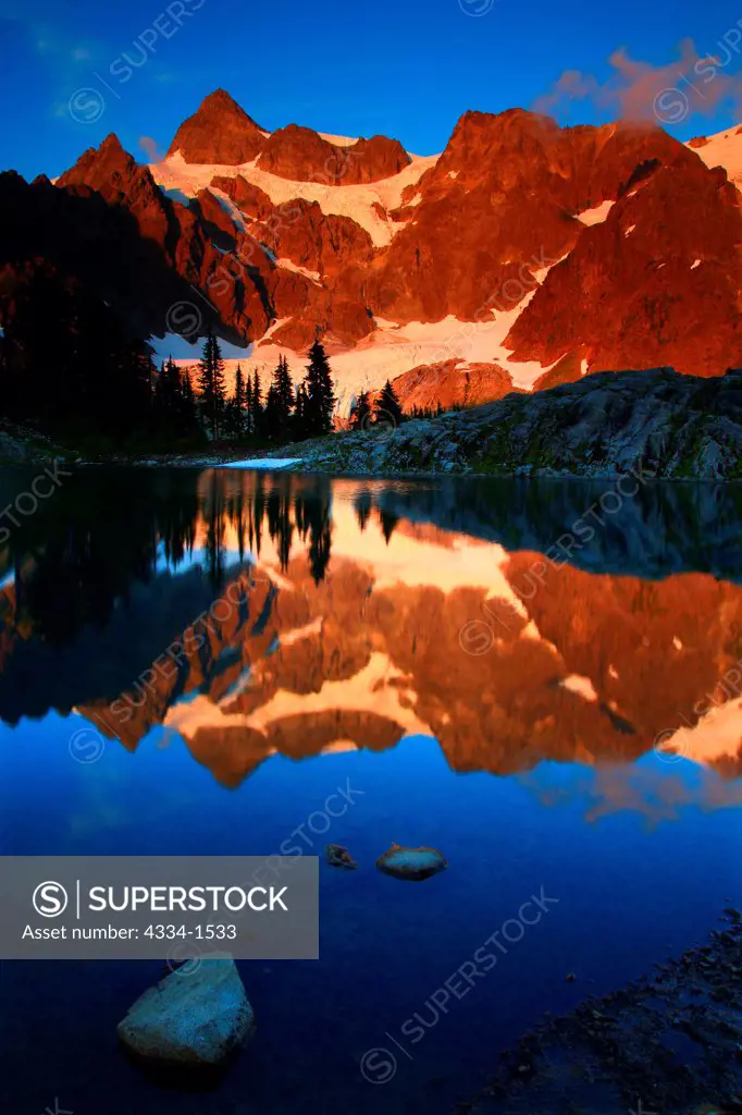 Reflection of a mountain range in a lake at sunset, Mt Shuksan, Lake Ann, Mt Baker Wilderness, Washington State, USA
