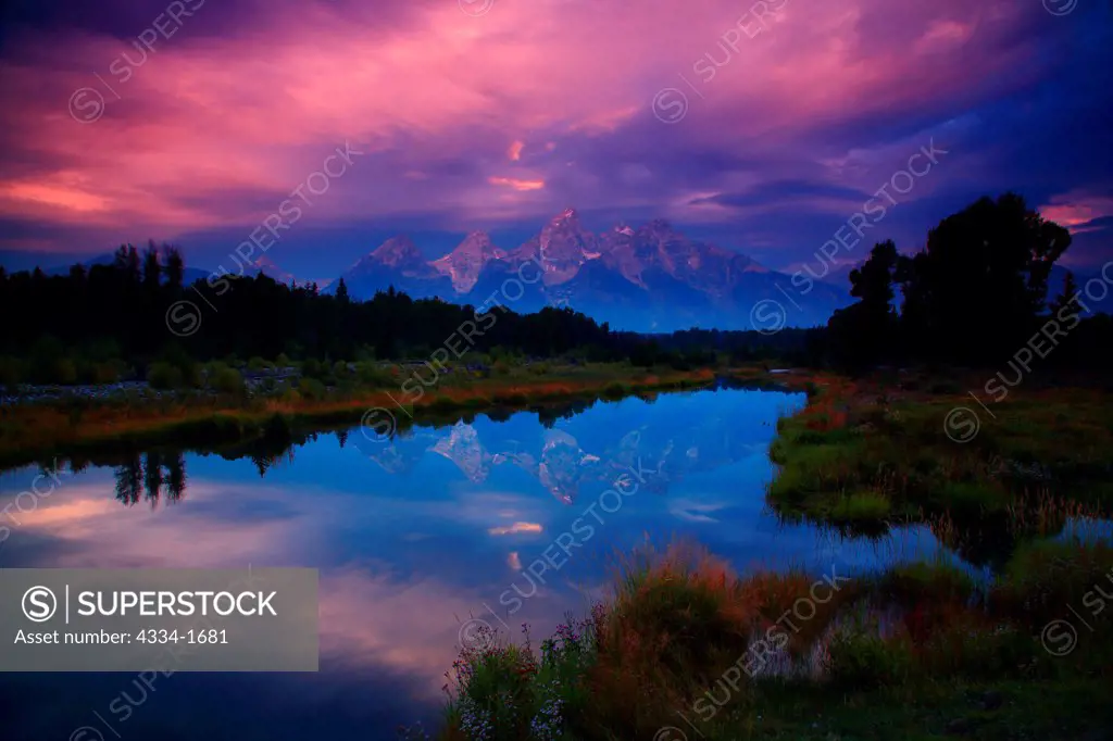 USA, Wyoming, Sunset with Grand Tetons reflected in Beaver Ponds along Snake River in Grand Teton National Park