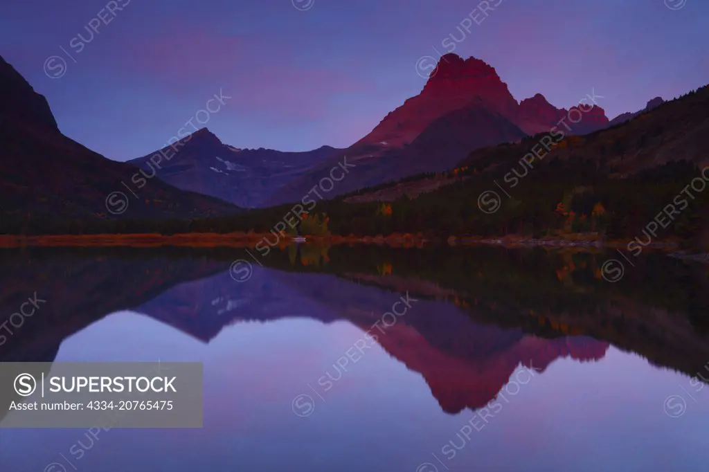 Sunrise Light on Mt Wilbur Reflected in Swift Current Lake in the Many Glacier Region of Glacier National Park in Montana