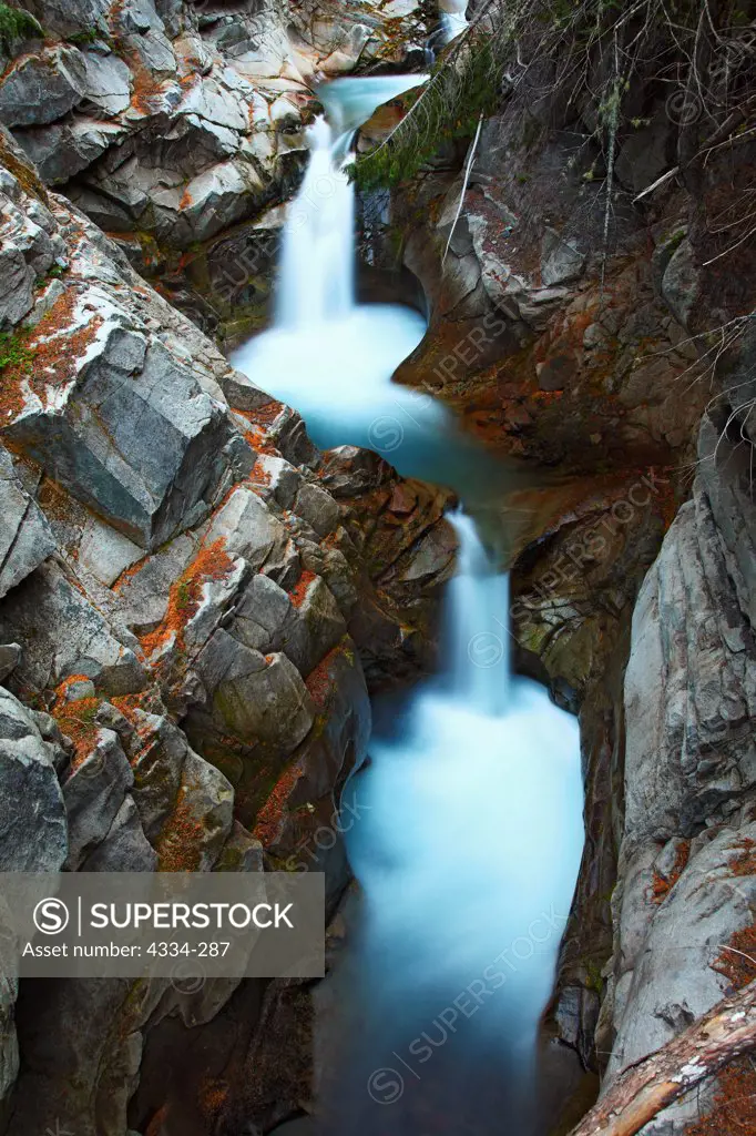 Waterfalls cascade through rugged rocks on Van Trump Creek, in Mount Rainier National Park.