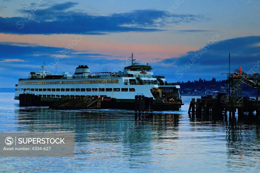 Ferry approaching Kingston Terminal in Washington at sunset.