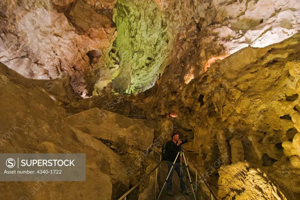 A photographer shoots the massive underground natural formations in the wondrous 8.2-acres Big Room cave, 750 feed into the Earth, Carlsbad Caverns National Park, Chihuahuan Desert, New Mexico.