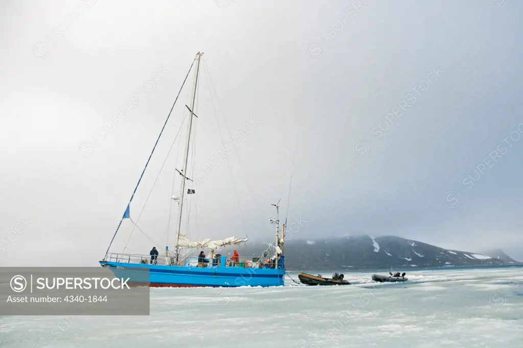 Photographers travel via a steel-hull sailboat to circumnavigate the Svalbard archipelago in summertime.