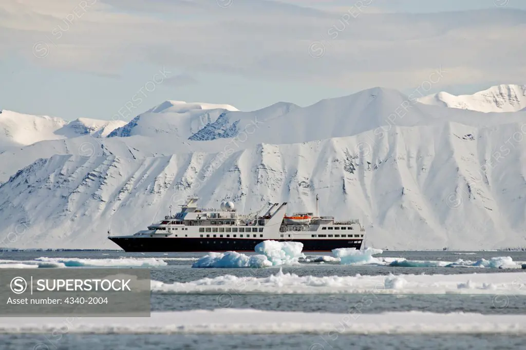 View of a luxury cruise vessel anchored in Liefdefjorden, Svalbard, Norway, in summertime.