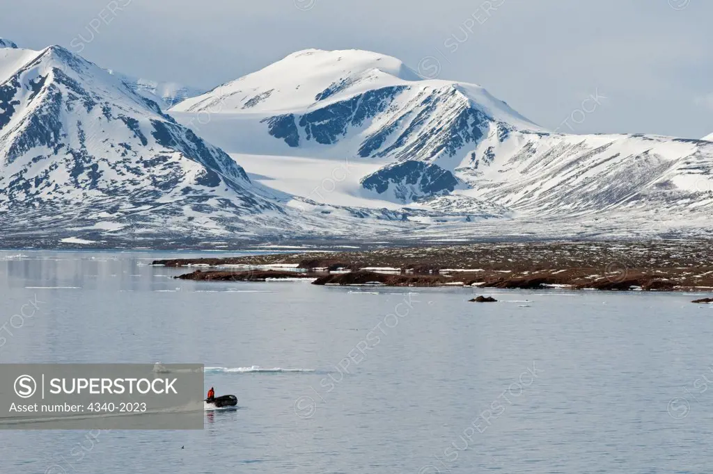 Zodiac heads out to Andoyane island to look for polar bears, Liefdefjorden, northwest Svalbard, Norway, in summertime.